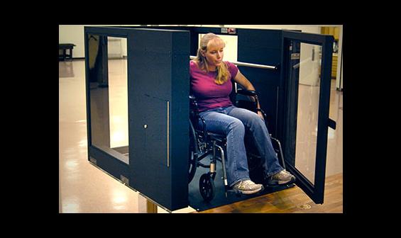 Handicapped woman using an Ascension Protege vertical wheelchair lift